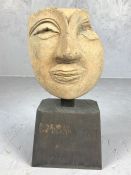 Terracotta death mask mounted on a wooden plinth, possibly Etruscan, height approx 20cm in height (