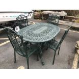 Green painted oval garden table and four chairs, table approx 138cm in length