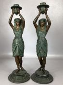 Pair of Egyptian painted metalware candlesticks, in the form of women, height approx 39cm