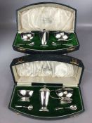 Pair of cased and matching condiment sets both hallmarked Silver and each with Salt, Mustard, Pepper