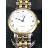 Omega De Ville circular white faced wristwatch on gold and silver coloured strap watch case numbered