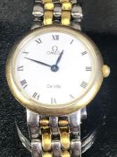 Omega De Ville circular white faced wristwatch on gold and silver coloured strap watch case numbered