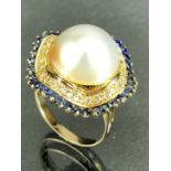 Large single Pearl on yellow gold mount surrounded by a halo of diamonds and then individually set