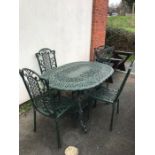 Green painted oval garden table and four chairs, table approx 138cm in length