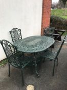 Green painted oval garden table and four chairs, table approx 138cm in length