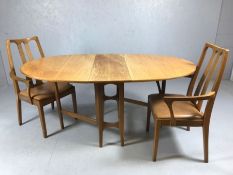 Mid Century drop leaf oval table and two carver chairs, all by NATHAN, table approx 167cm x 98cm