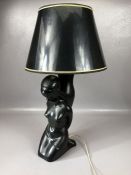 Retro / vintage black ceramic table lamp in the form of a kneeling women with black and gold