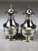 Pair of weighted silver cruets, salt and pepper pots