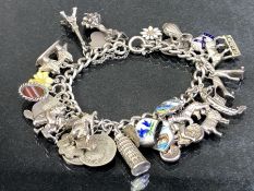 Silver Charm Bracelet with over 25 charms including coins