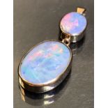 Pendant of Two Oval cut Opals framed in 9ct Hallmarked Gold, the largest approx 27mm long and