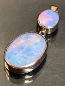 Pendant of Two Oval cut Opals framed in 9ct Hallmarked Gold, the largest approx 27mm long and