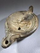 Roman oil lamp with depiction of an erotic scene, approx 10cm in length