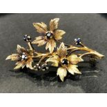 9ct Gold fully hallmarked Brooch, a Floral spray set with seven Sapphires approx 48mm in length &