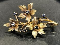 9ct Gold fully hallmarked Brooch, a Floral spray set with seven Sapphires approx 48mm in length &