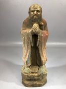 Small carved Chinese wooden figure of a man with his hands clasped, remnants of paint present,