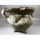 Ceramic / pottery pipkin or skillet with partial green glaze, on three feet with single handle,