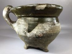 Ceramic / pottery pipkin or skillet with partial green glaze, on three feet with single handle,