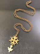 9ct Gold chain with unmarked Gold coloured pendant depicting a four pointed star and a Dove of peace