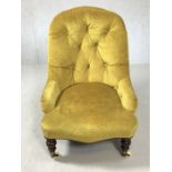 Upholstered nursing chair on original castors in gold fabric, approx 77cm in height