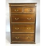 Tall chest of three large and two small drawers with carved detailing and brass handles. approx 87cm