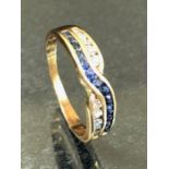 9ct Gold Cross over ring set with white and blue stones size 'R' approx