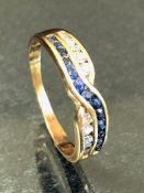 9ct Gold Cross over ring set with white and blue stones size 'R' approx