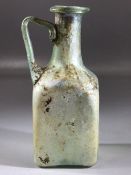 Square glass bottle, possibly Roman, in translucent blue/green glass, cylindrical neck very slightly