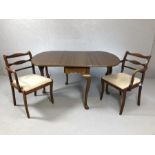 Drop leaf table on cabriole legs, with two carver chairs, table approx 144cm x 107cm fully extended