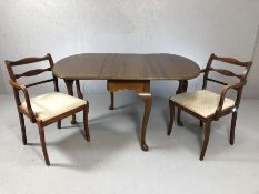 Drop leaf table on cabriole legs, with two carver chairs, table approx 144cm x 107cm fully extended