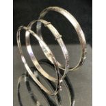 Three silver bangles