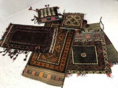 Good collection of Eastern textiles to include camel saddle bag, two cushions etc (5)