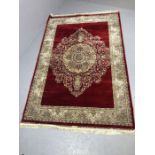 Red ground woven silk floral medallion pattern rug approx. 240cm x 160cm