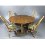 Blond Ercol drop leaf table, accompanied by four swan back dining chairs, table approx 140cm x 127cm