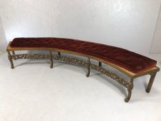 Large oak and rush seated curved window seat, heavily carved, on eight legs, with carved heart