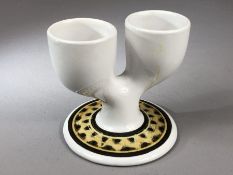 Troika Pottery - a double egg cup in white with brown painted decoration to the circular foot,