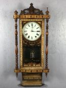 Edwardian wall clock with inlaid and carved detailing, turned supports and ornate pendulum, with