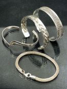 Collection of four modern silver bangles