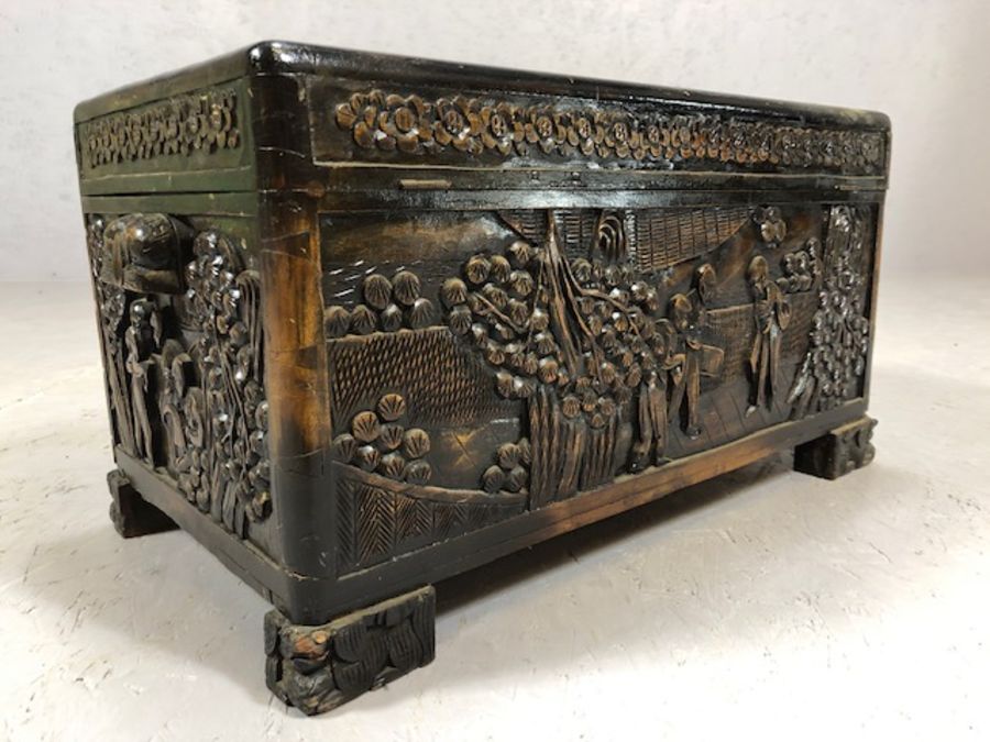 Small heavily carved Chinese camphor wood chest with brass fittings on square carved feet, approx - Image 7 of 9