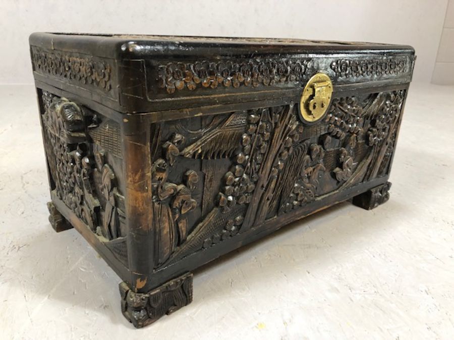 Small heavily carved Chinese camphor wood chest with brass fittings on square carved feet, approx - Image 4 of 9