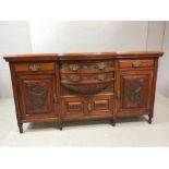 Heavily carved mahogany sideboard with brass handles, drawers and shelved cupboards, approx 184cm