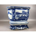 Blue and white Chinese planter on stand with panels depicting Chinese countryside scenes, total