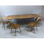 Ercol blond elm extending dining table table with pull-out action and drop-in hinged leaf, approx