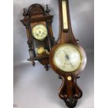 Vienna-style wooden cased wall clock with pendulum and key along with a mercury wooden cased wall