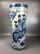 Large Oriental themed umbrella stand with blue and white decoration and blue character mark to base,