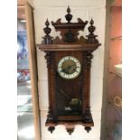 Wall hanging Vienna clock with key and weight and turned finials