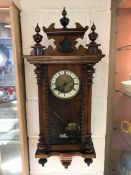 Wall hanging Vienna clock with key and weight and turned finials