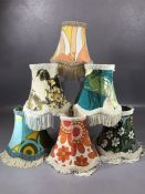 Six retro lamp shades in varying vintage fabrics, each approx 14cm in diameter