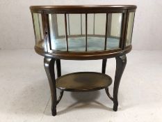 Oak framed glass panelled silver table with shelf beneath, on serpentine legs, upper glass has