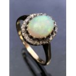 9ct yellow Gold ring set with a large Opal surrounded by diamonds all set in platinum size 'P' (Opal