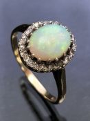 9ct yellow Gold ring set with a large Opal surrounded by diamonds all set in platinum size 'P' (Opal